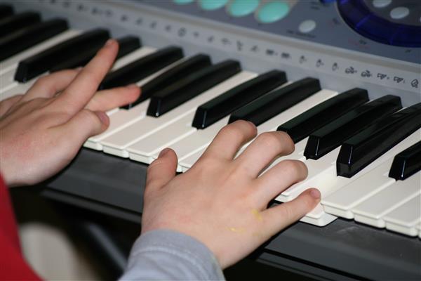 Child's hands playing the piano 