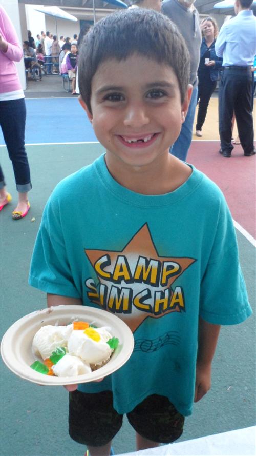 Picture of a boy smiling while holding a bowl of ice cream Picture of a boy smiling while holding a bowl of ice cream - one happy customer