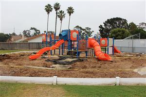 Kindergarten Play structure at Solana Vista. Orange and Blue with slides and climbing elements 