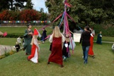 Students dancing around a maypole 