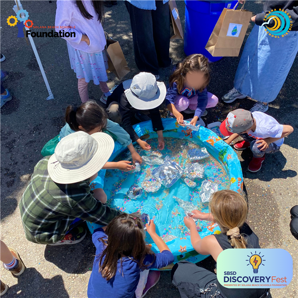 Photo features SBSD students interacting with a Discovery Lab station at Discovery Fest 2023.