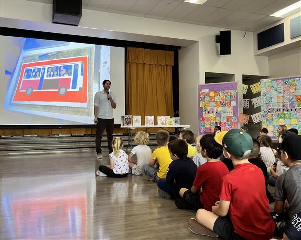 Newbery Medalist Matt de la Pena shares his book with students in an assembly