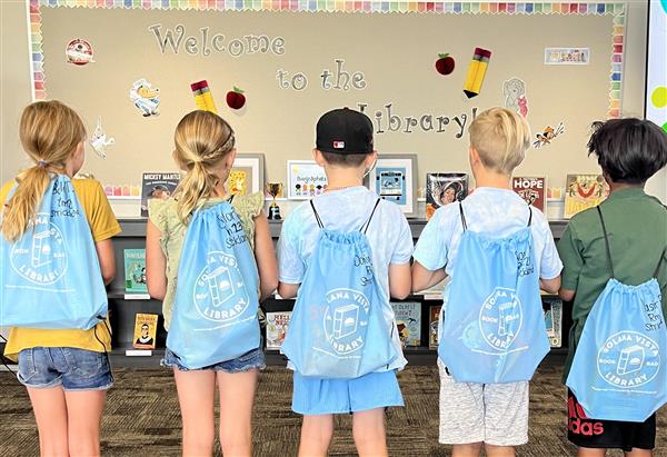 Backs of students model light blue Library Book backpacks