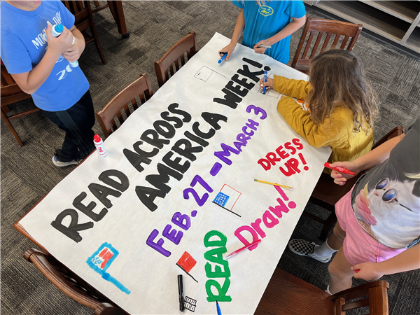 Students paint and decorate a poster for Read Across America Week