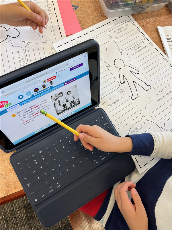 Image of a student iPad conducting biography research on an App